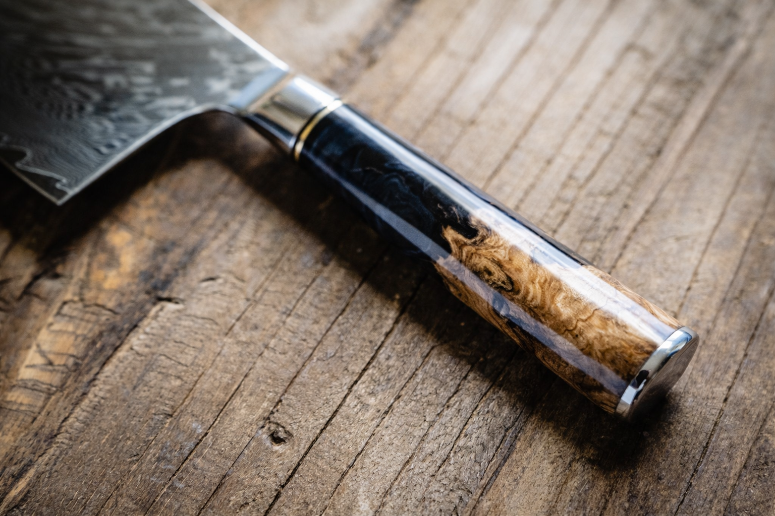 Black burl handle close-up on personalized engraved Damascus knife — Tidal Series